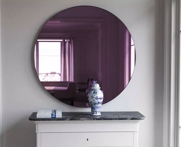 pink coloured round mirror