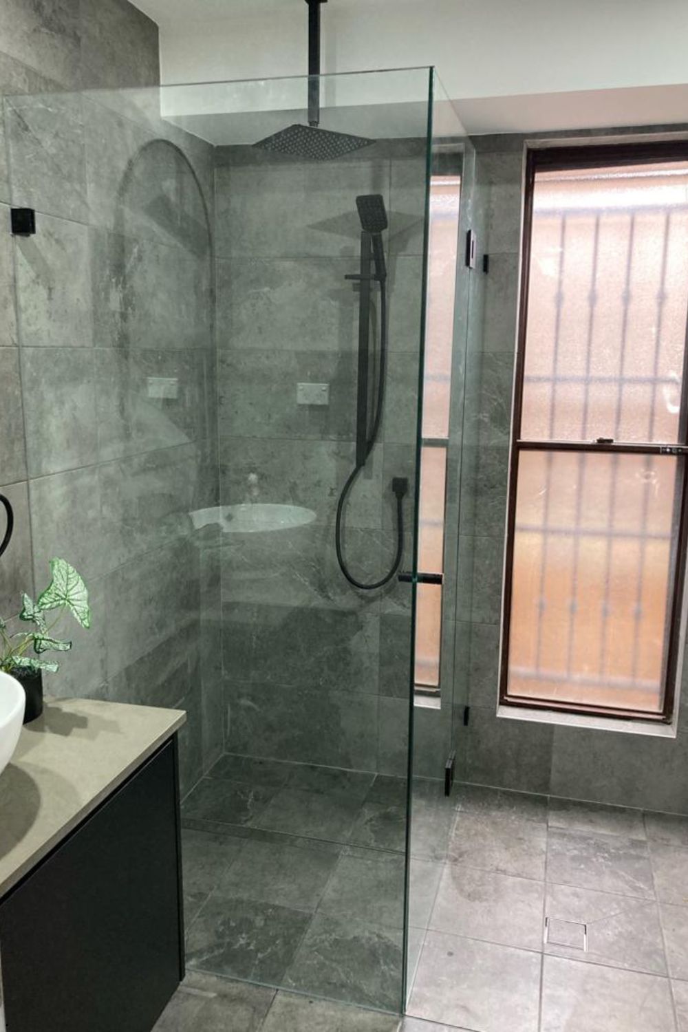 Frameless Return Panel Shower Screen with Black Fittings