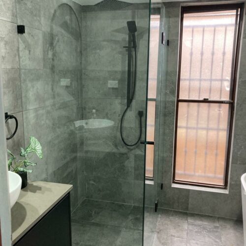 Frameless Return Panel Shower Screen with Black Fittings