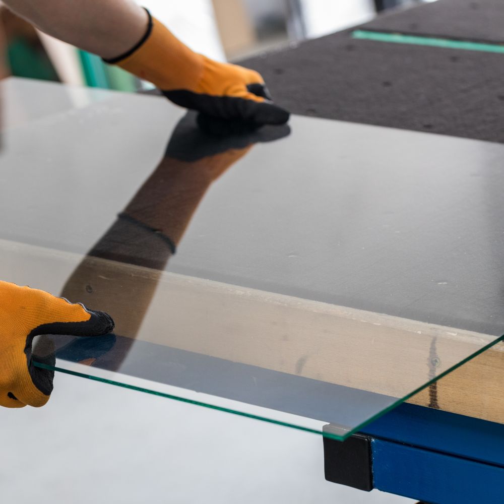 glazier lifting a glass made for table top